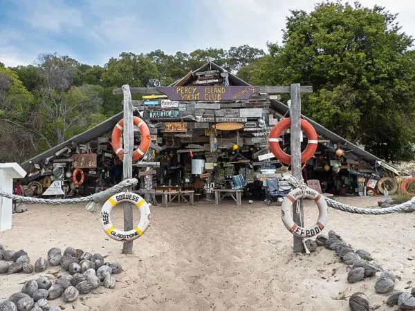 The Percy Island Yacht Club hut on Middle Percy, hung with lifebuoys and signs left by passing yachts