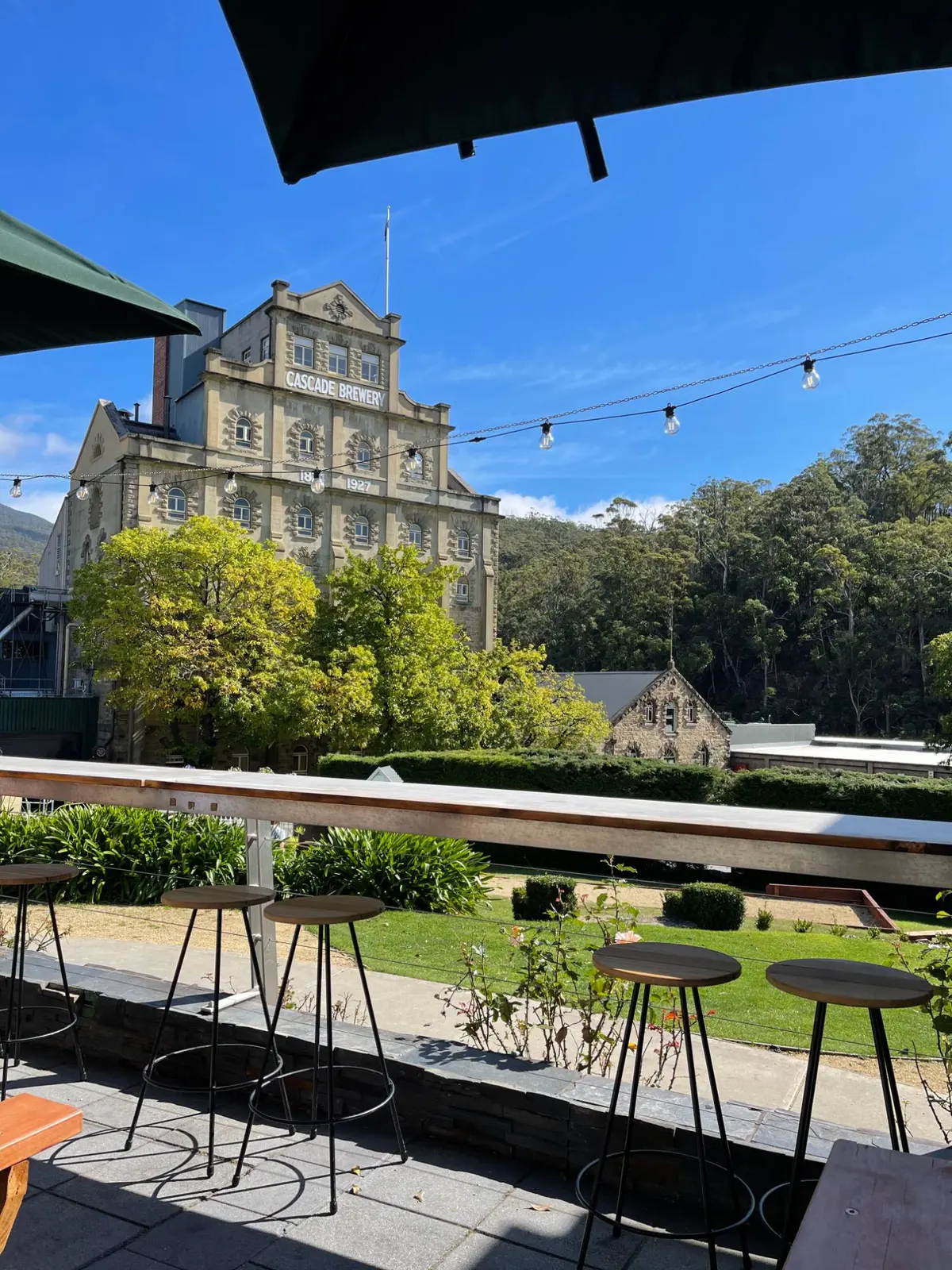 The terrace at Cascade Brewery in Hobart, looking across the garden to the 1824 brewery building