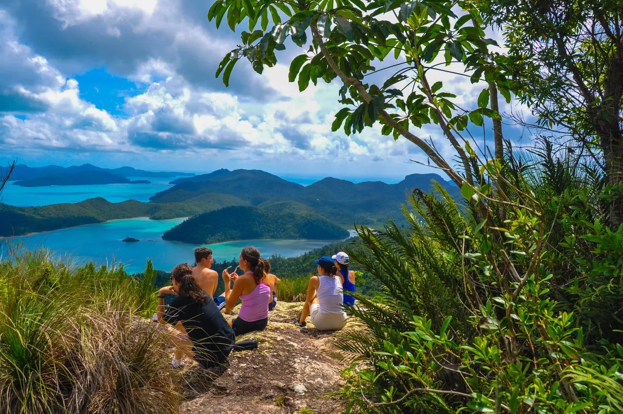 Guests resting at a Whitsundays lookout above the islands and turquoise water