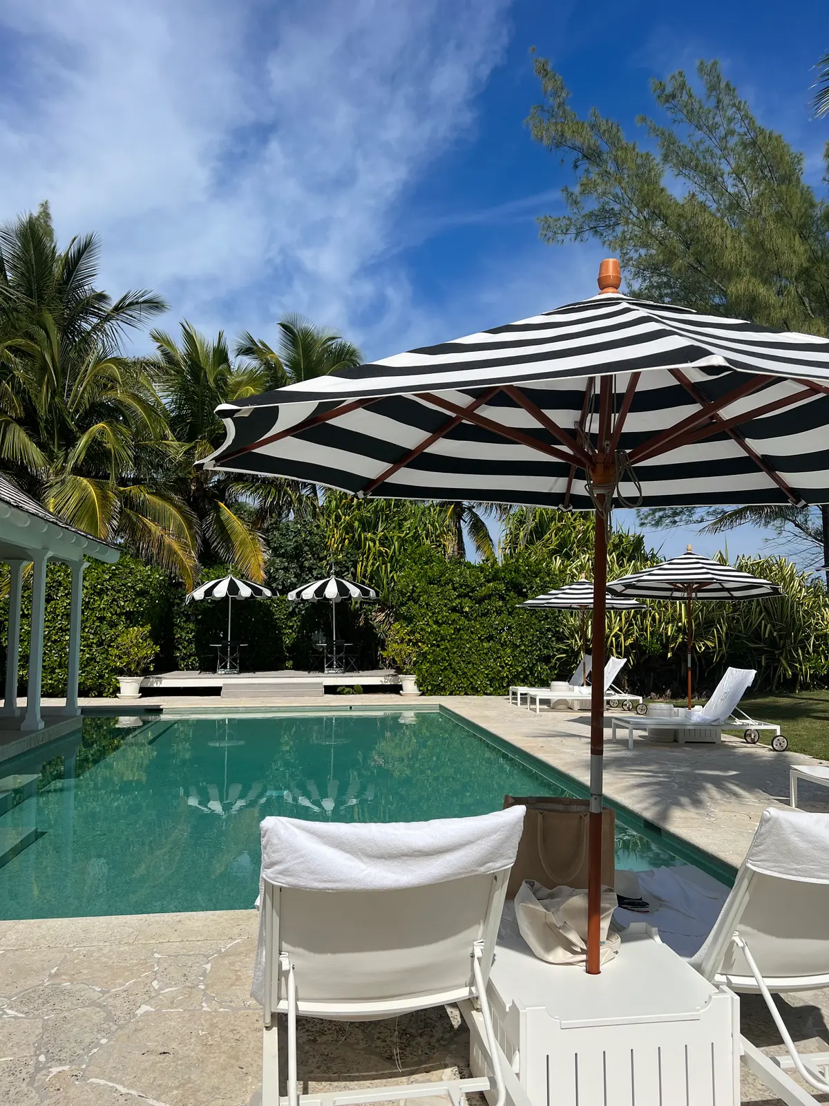 Striped umbrellas round the pool at the Dunmore