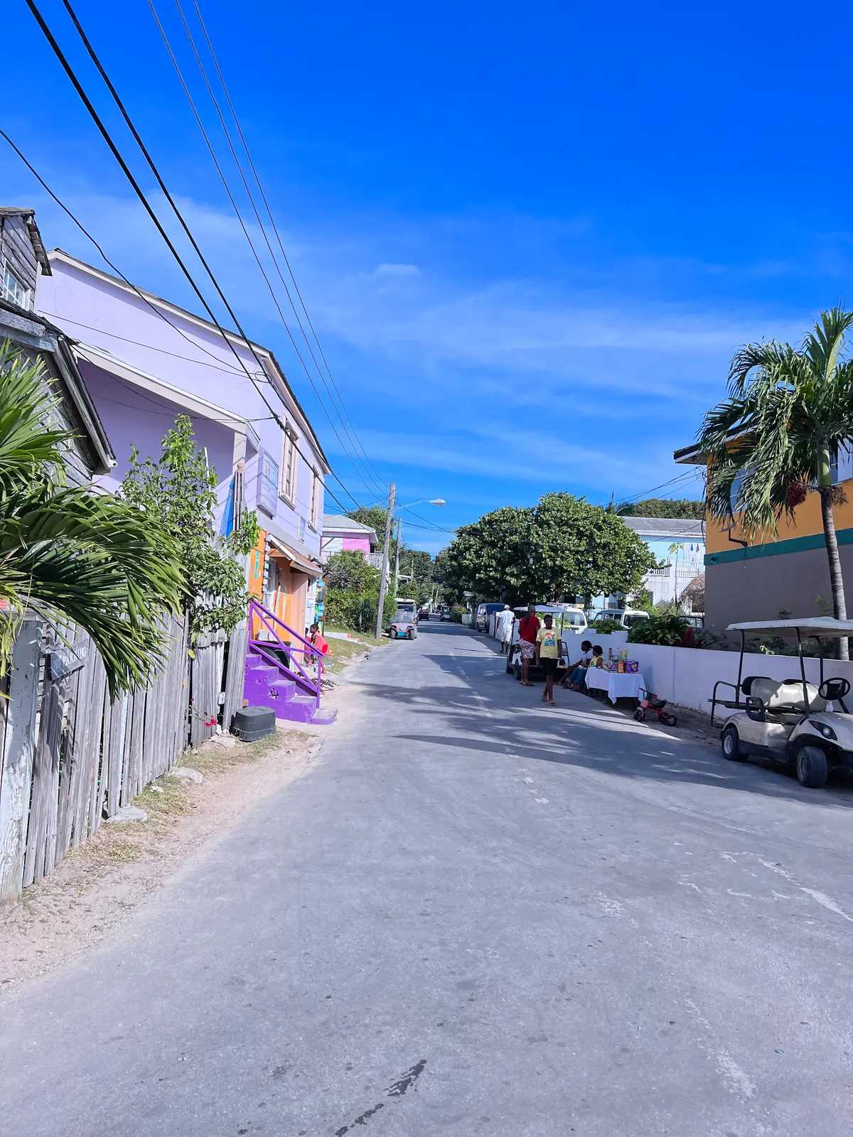 A back street in Dunmore Town, golf buggies and pastel houses