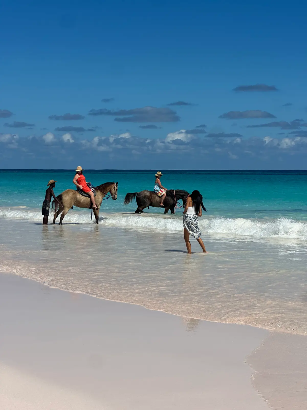 Two riders on horses in the surf on Pink Sands Beach, Harbour Island