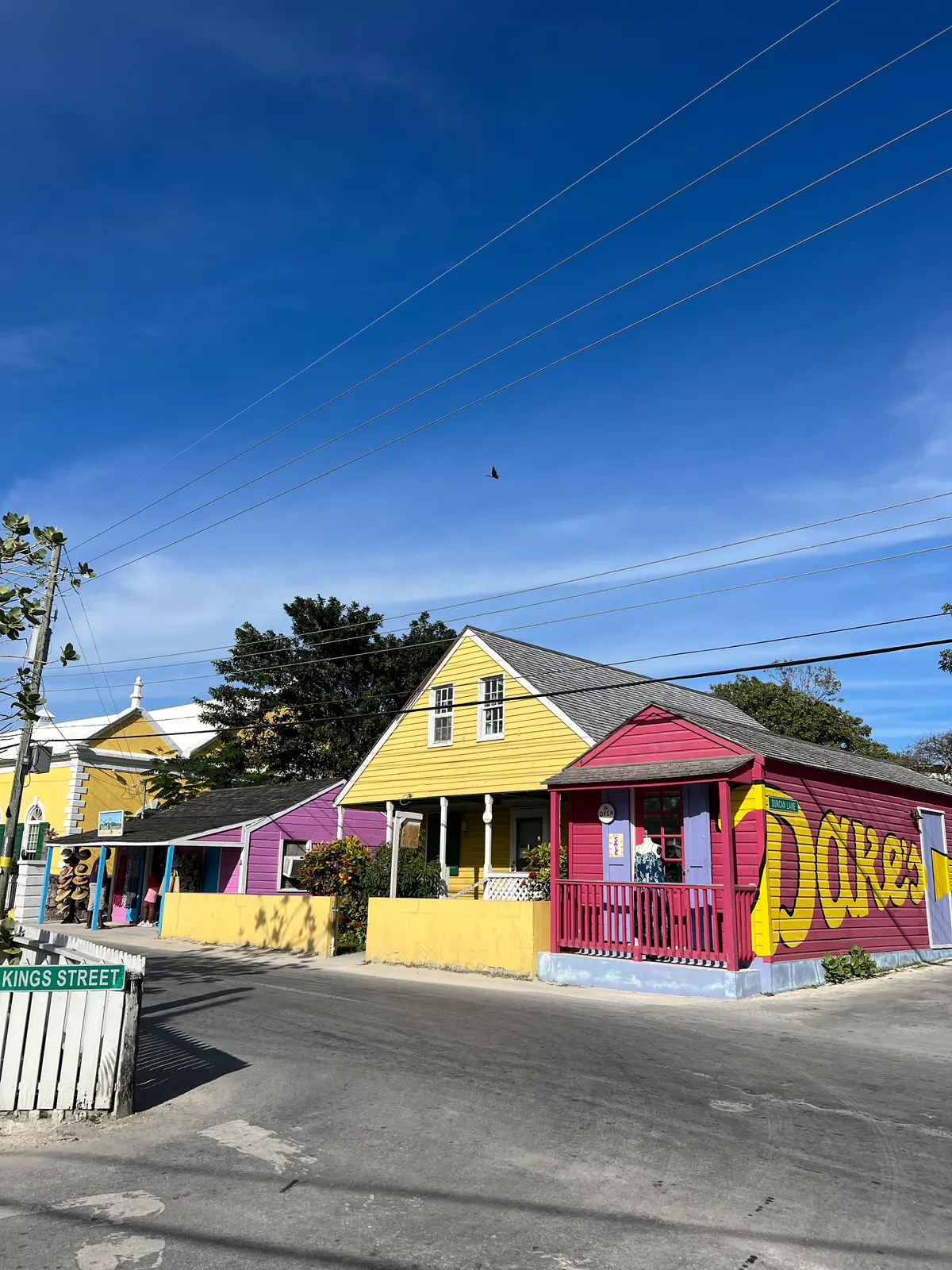 Yellow, pink and purple clapboard shops on Kings Street, Dunmore Town