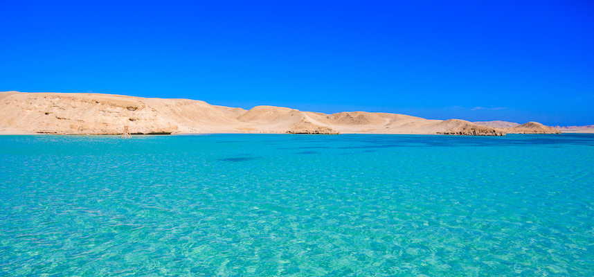 blue waters on red sea with white sand on background