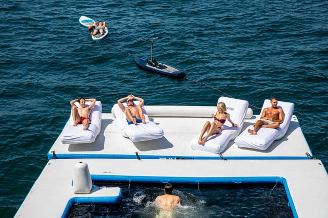 4 people lounging on the back of a superyacht floating platform