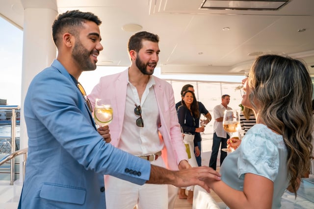 group of people chatting at an event on a yacht