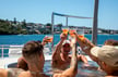 group of people in a hot tub on a yacht toasting a cheers 