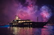 Fireworks behind a yacht on the water
