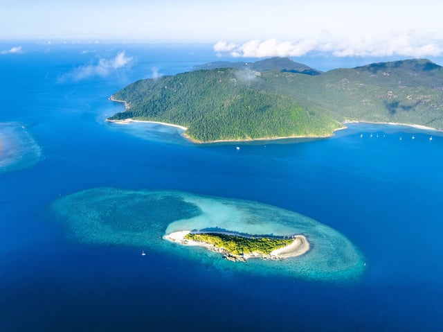 Stunning aerial high angle view of Black Island with a beautiful reef and Hook Island in the background