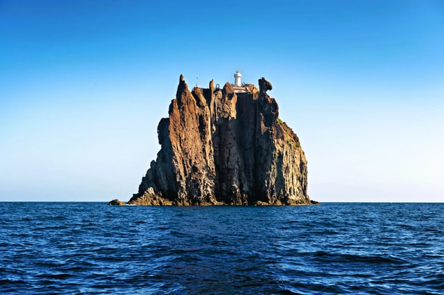 A tiny lighthouse perched on Strombolicchio in the Italian Aeolian islands