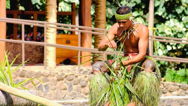 A young Samoan man demonstrating the art of weaving in the Village of Samoa at the Polynesian Cultural Center