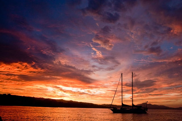 Schooner at anchor on Guadalcanal Island in Solomon Islands in South Pacific at sunset