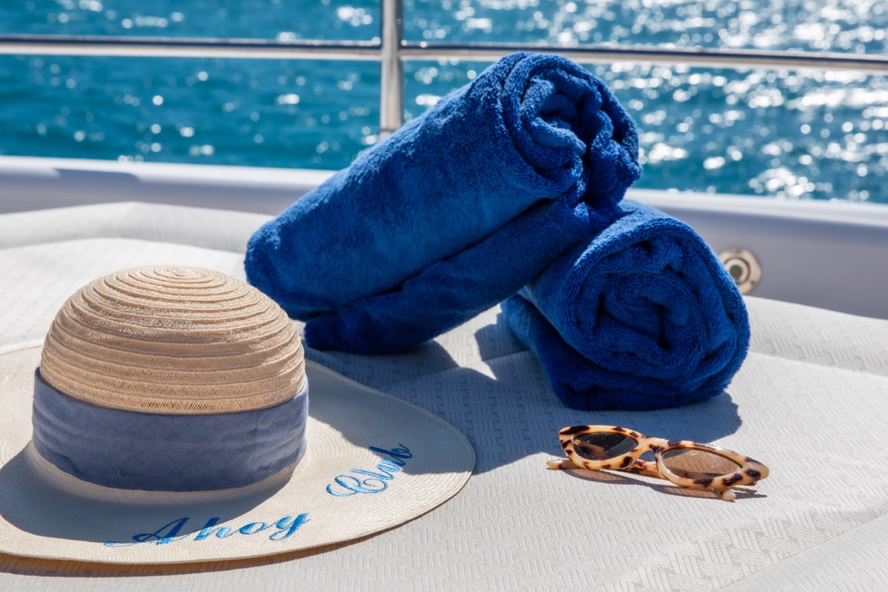 image of hat and towl on yacht day bed